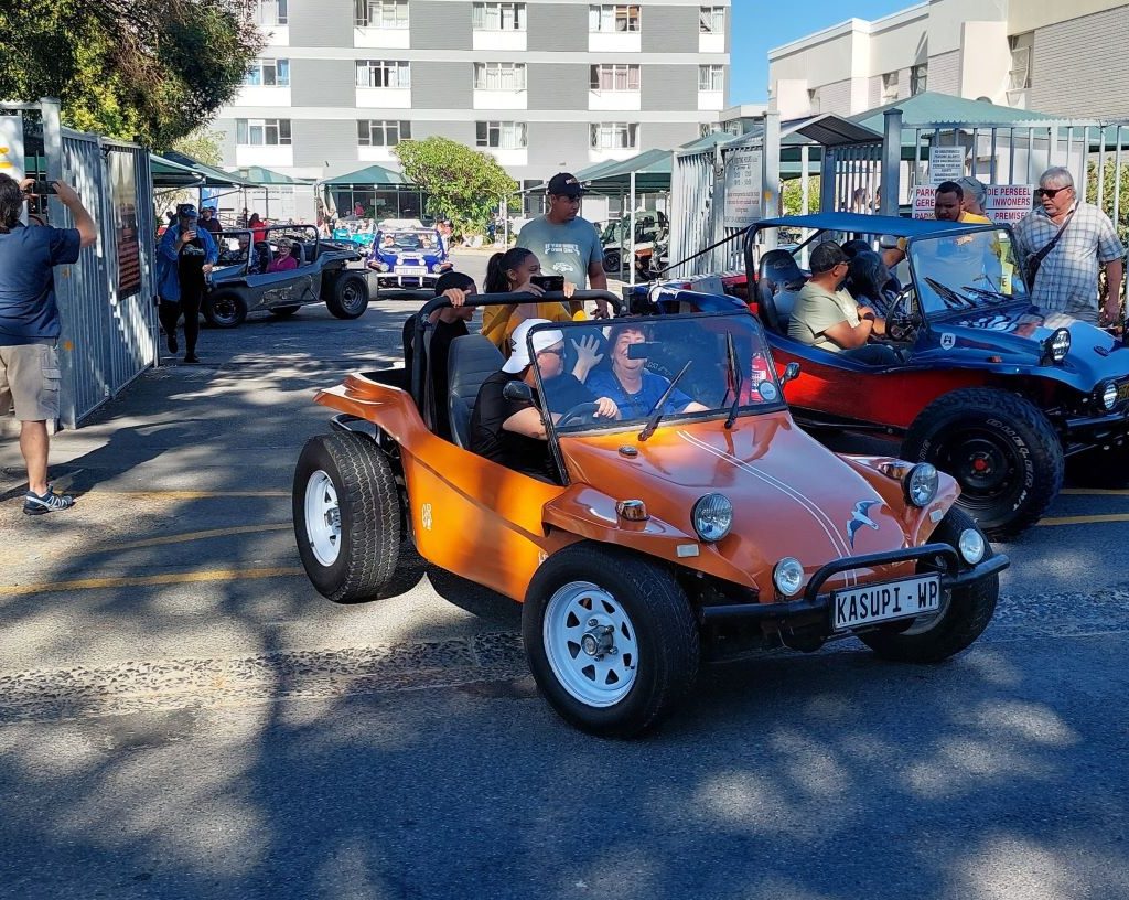 Adelle driving a senior resident in her custom beach buggy during The Wild Buggers Beach Buggy Club charity event.