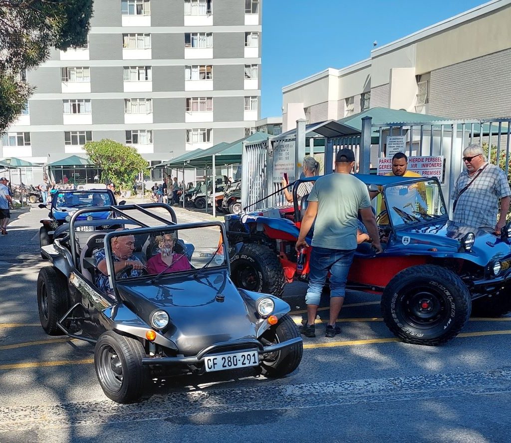 Jaco driving a senior resident from Huis Uitsig in his classic Beamish beach buggy during a Wild Buggers club run.