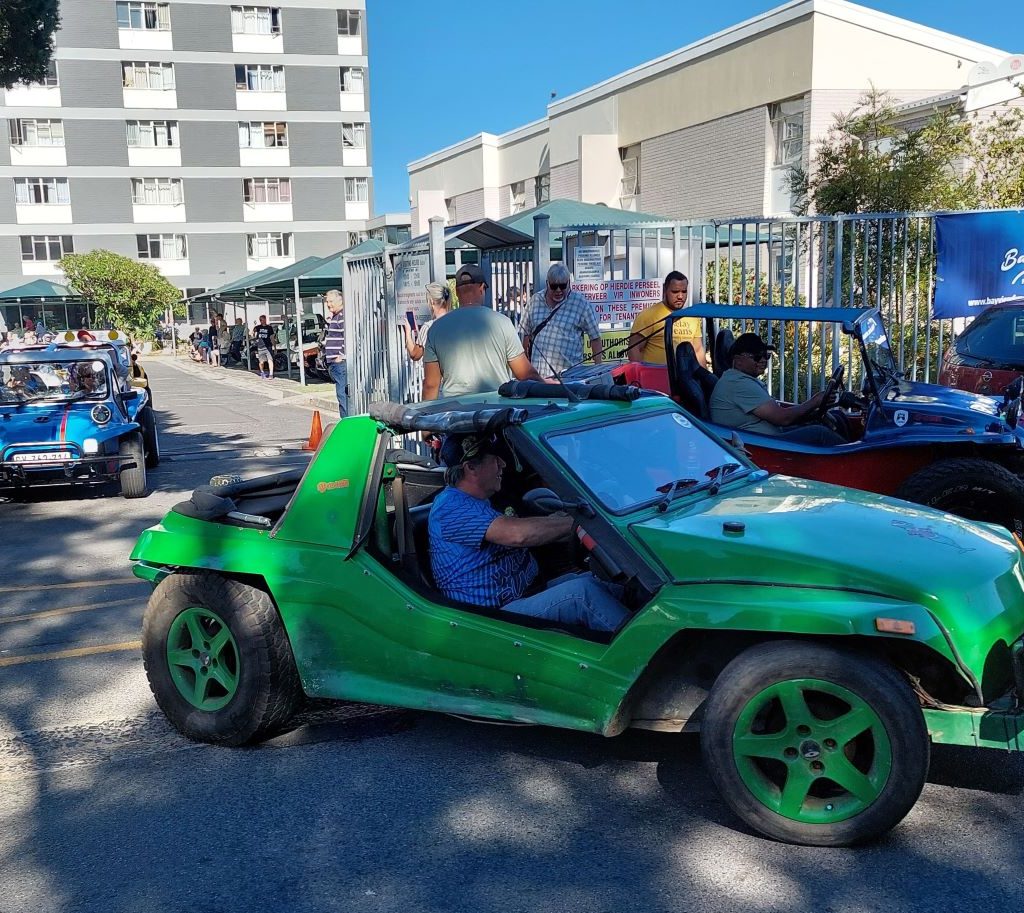 Anton Kleyn, President of The Wild Buggers Beach Buggy Club, taking a senior resident for a spin in his VW air-cooled beach buggy.