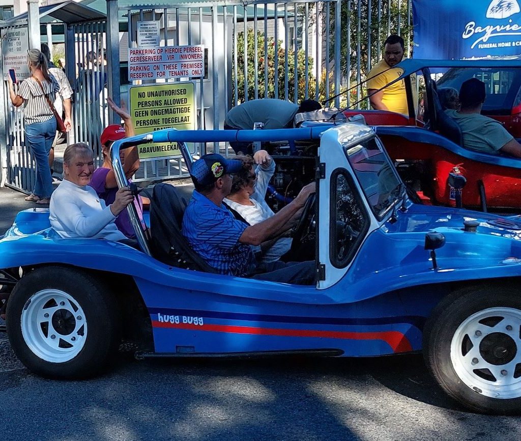 Jessie Hugget driving a senior resident in a classic VW air-cooled beach buggy during The Wild Buggers charity event.