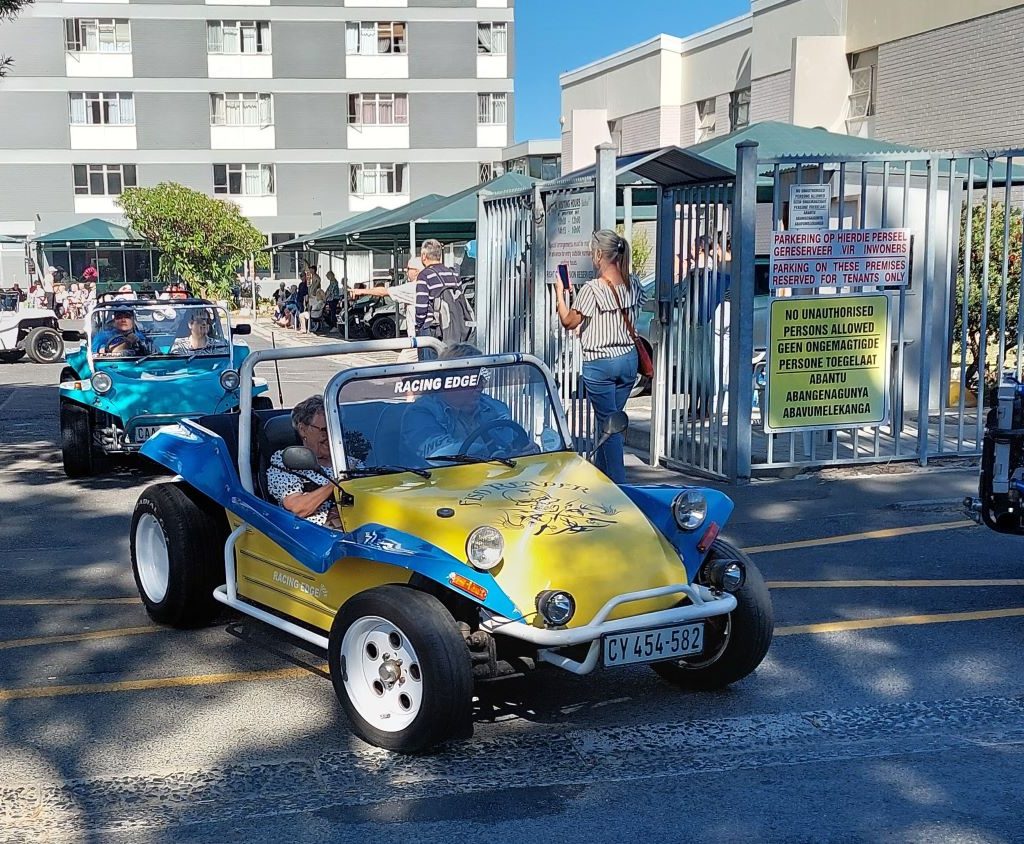 Hannes taking a senior resident for a spin in his classic VW air-cooled beach buggy at the Huis Uitsig charity event.