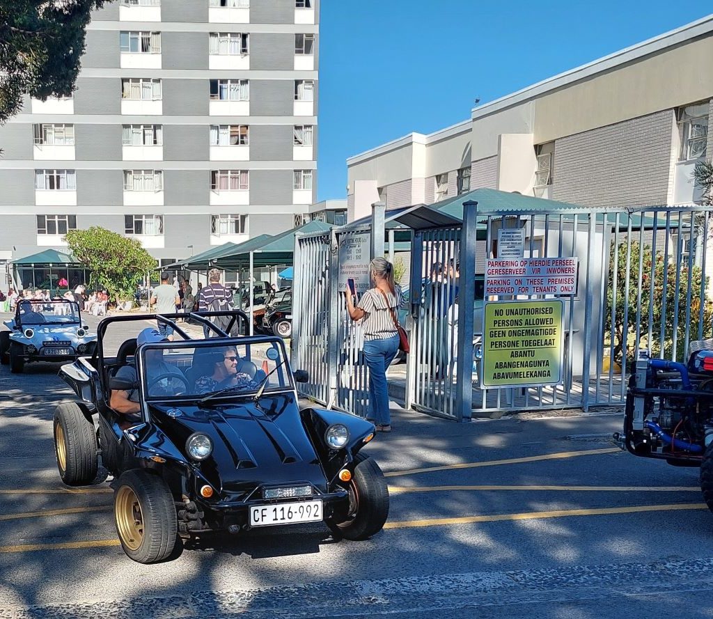 A sleek black VW beach buggy taking a senior resident for a drive during The Wild Buggers charity event.