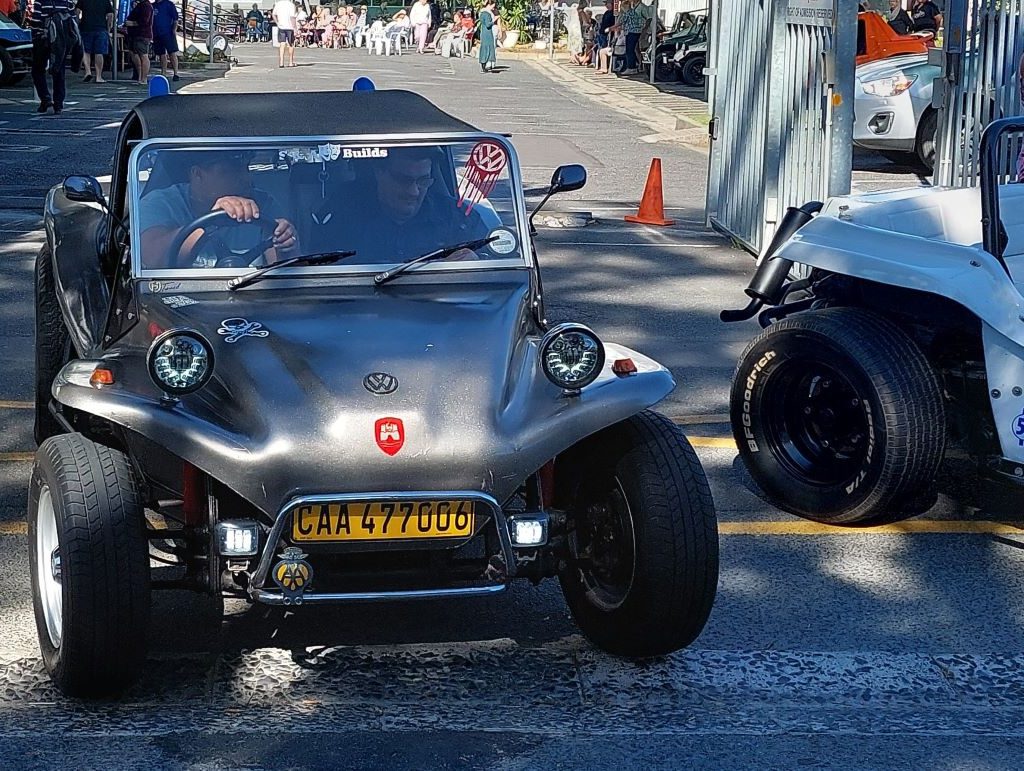Ashley taking a senior resident for a drive in his beach buggy during The Wild Buggers charity event at Huis Uitsig.