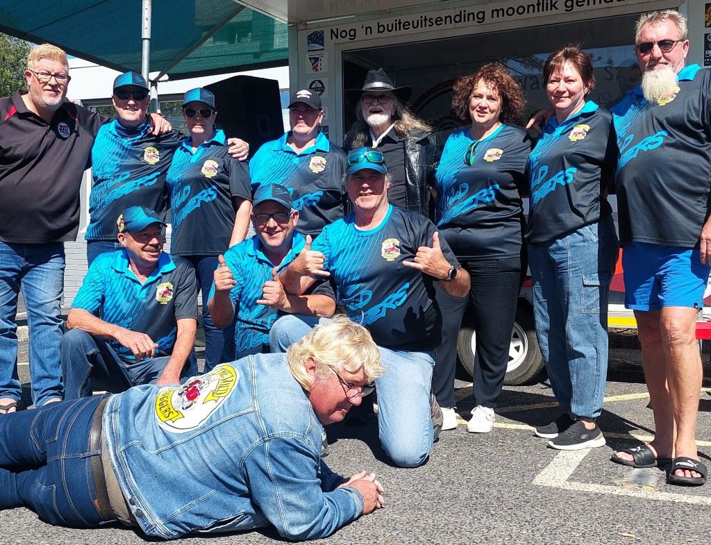 Members of The Wild Buggers Beach Buggy Club standing together for a group photo at a charity event.