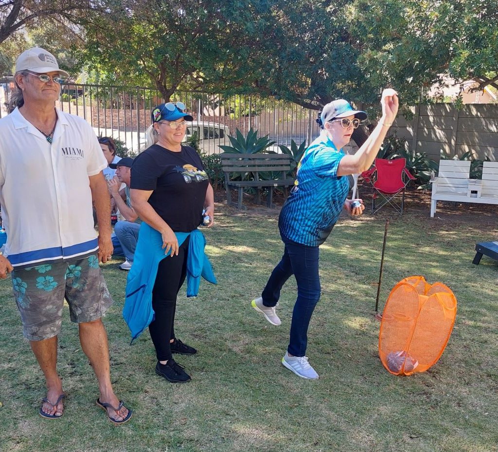 Members of The Wild Buggers Beach Buggy Club playing games and interacting with senior residents at Huis Uitsig.