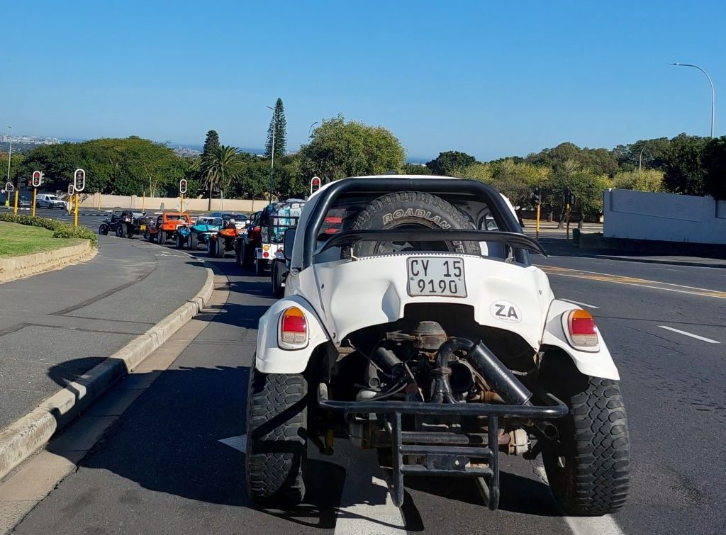 Back view of the Wild Buggers Beach Buggy convoy driving towards the Huis Uitsig Charity event in the Western Cape.