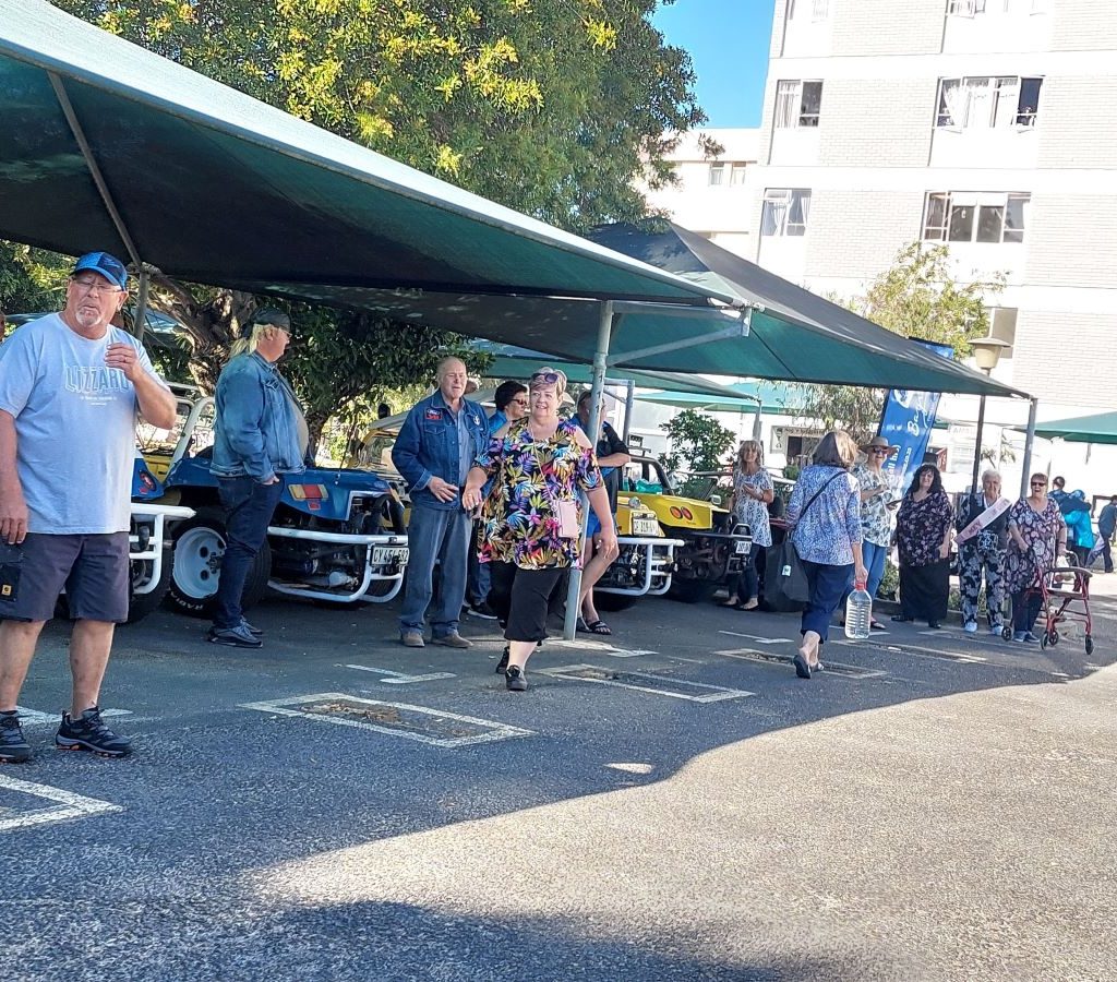 Wild Buggers Beach Buggy Club members parking their VW air-cooled vehicles and socializing at Huis Uitsig during the charity event.