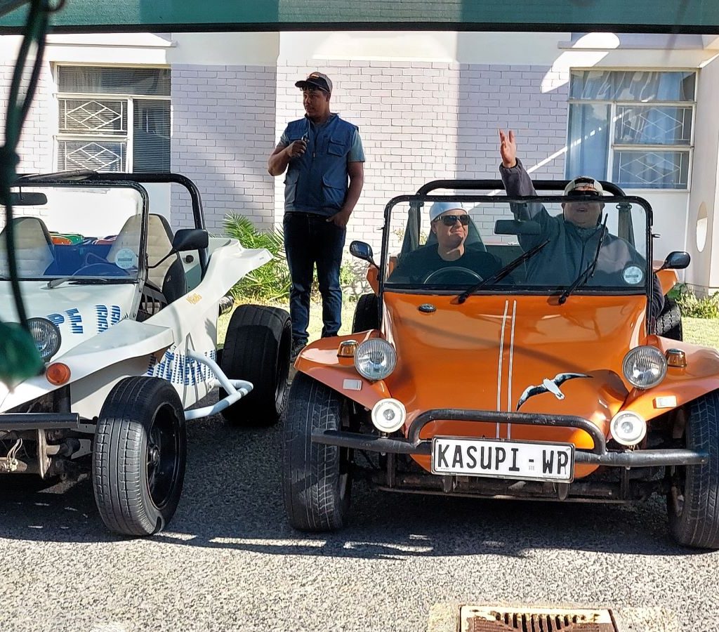 Landria’s orange Beach Buggy, "Kasupi," parked at Huis Uitsig during the Wild Buggers Beach Buggy Club charity event.
