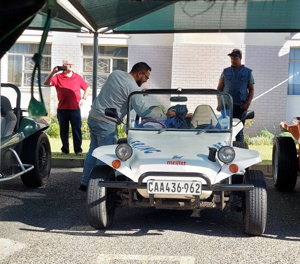 A classic white Beamish Beach Buggy parked with the Wild Buggers convoy at the Huis Uitsig Charity event.