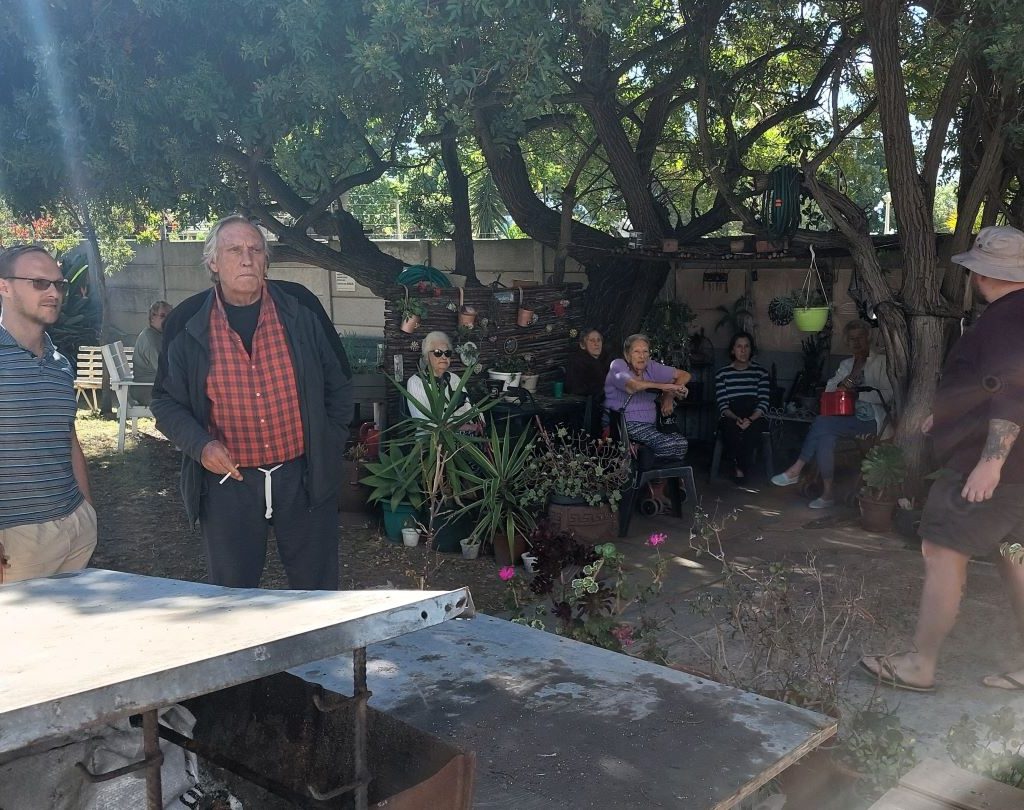 Seniors at Huis Uitsig retirement home sitting in the shade and enjoying the Wild Buggers Beach Buggy Club charity event.