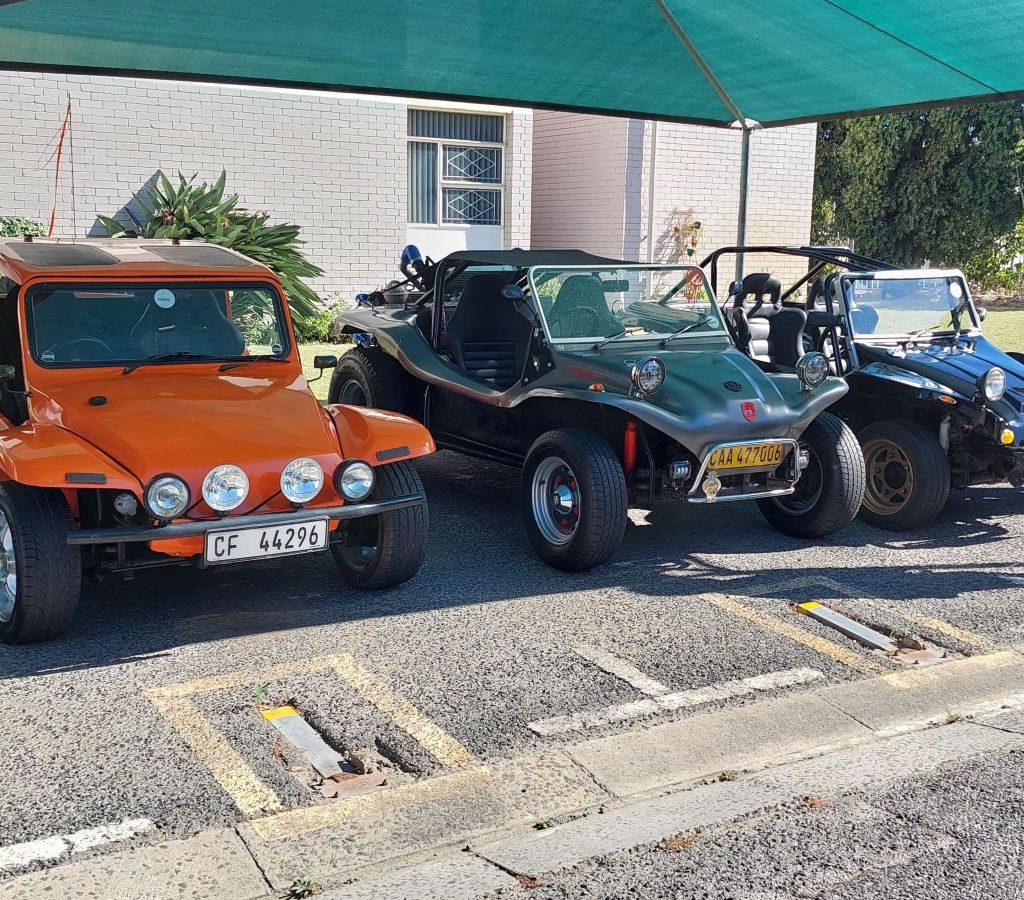 A line of colorful Beach Buggies and VW air-cooled vehicles parked and ready for the Wild Buggers Beach Buggy Club event.