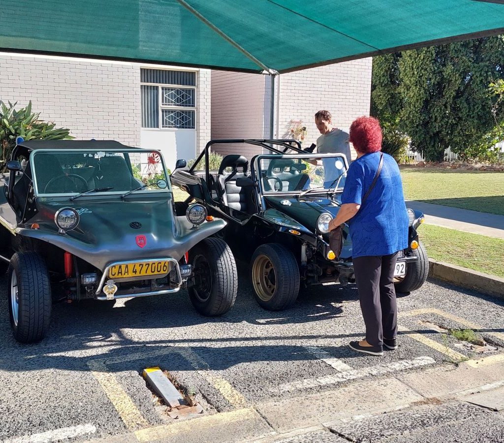 Two custom beach buggies parked side-by-side at a Wild Buggers Beach Buggy Club event.