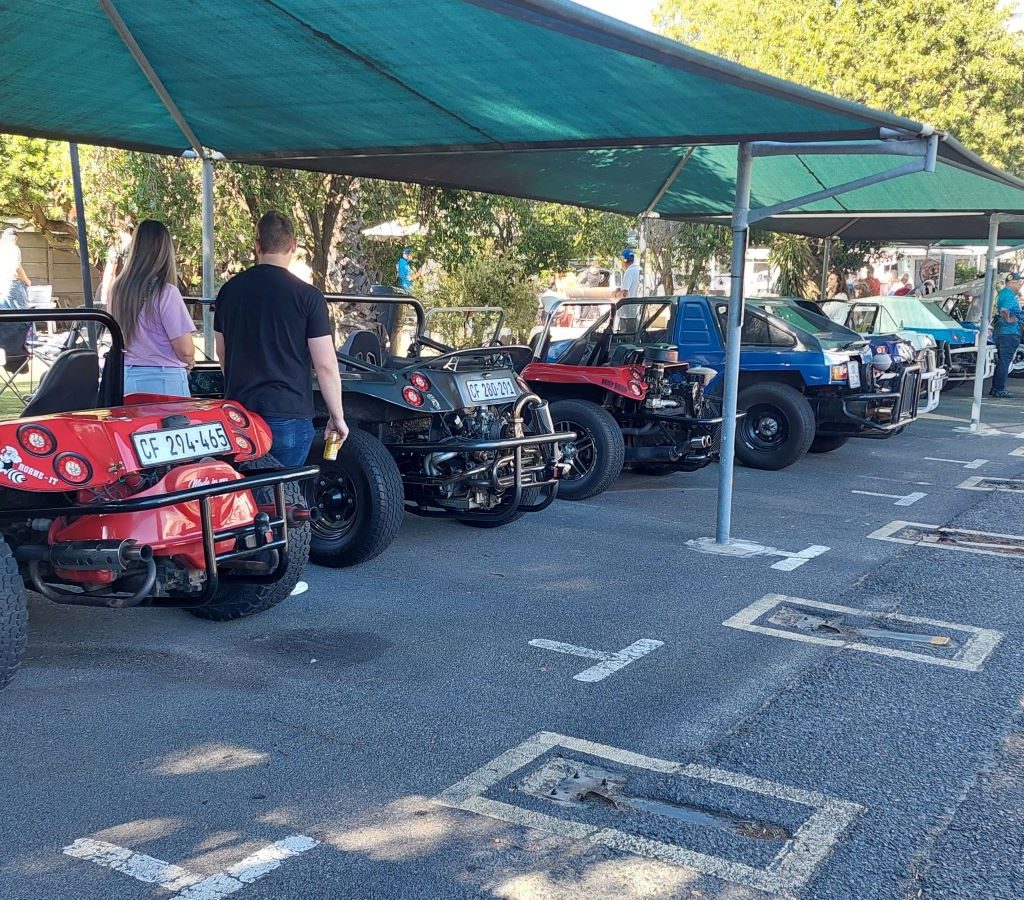 A collection of various custom beach buggies and VW air-cooled vehicles parked together at the Wild Buggers Beach Buggy Club charity event.