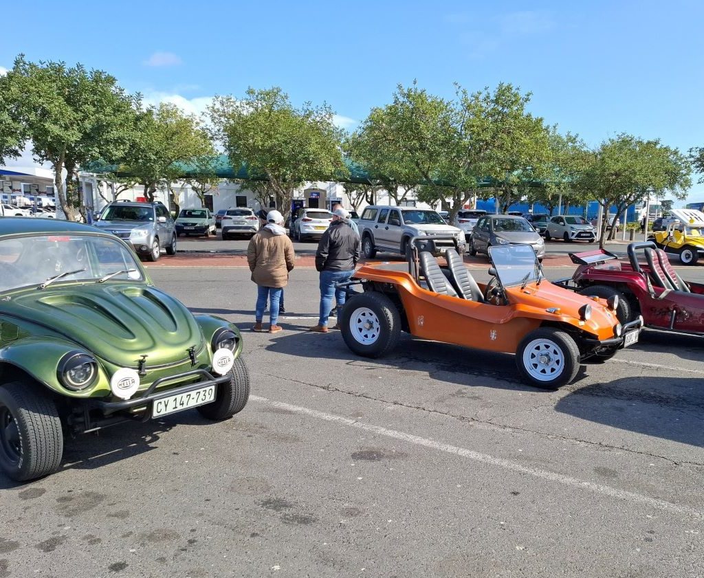 Mickey’s green Baja Bug, The Dark Side, and Adele and Landria’s orange Beamish beach buggy parked at Engin 1 Stop during the Wild Buggers Paarl Run.