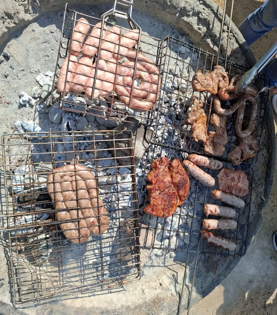 A variety of meats grilling on the braai at a Wild Buggers Beach Buggy Club event.