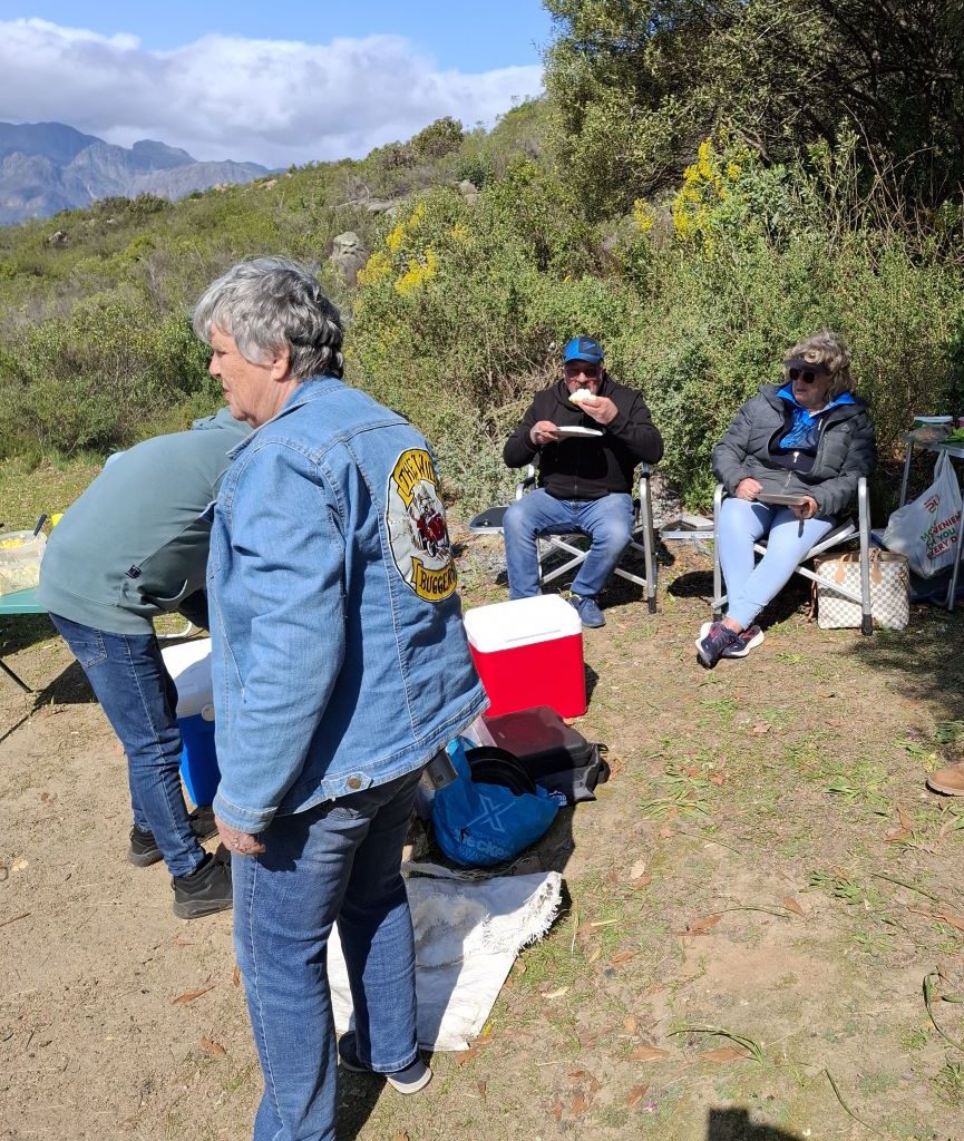 Wild Buggers Beach Buggy Club members eating, chatting, and preparing to braai.