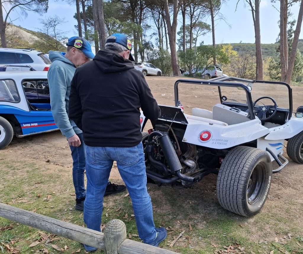 Jess and Nick discussing a motor issue on Nick’s white Beamish beach buggy during a Wild Buggers Beach Buggy Club event.
