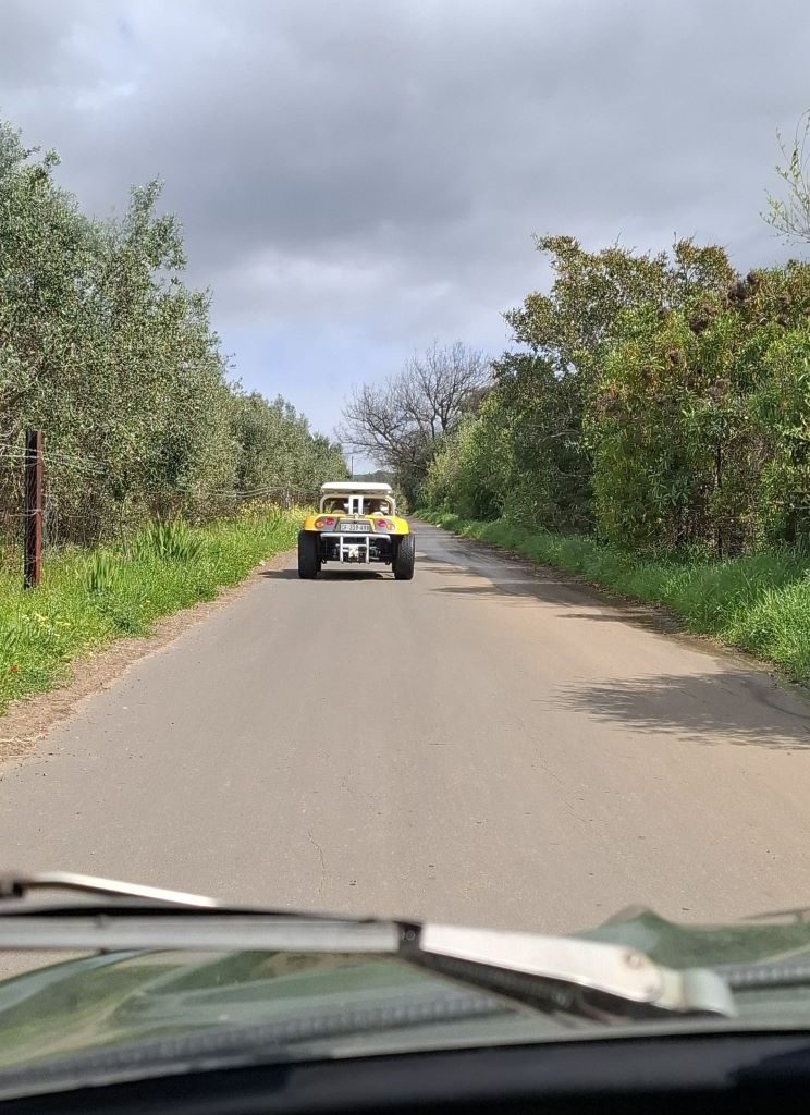 Chris Zara’s yellow Salamander beach buggy driving up the gravel road in Paarl towards the braai spot.