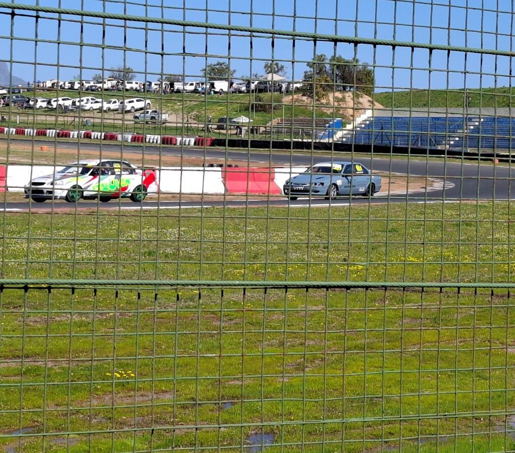Racing cars in action on the track, showcasing their speed and agility during an event.