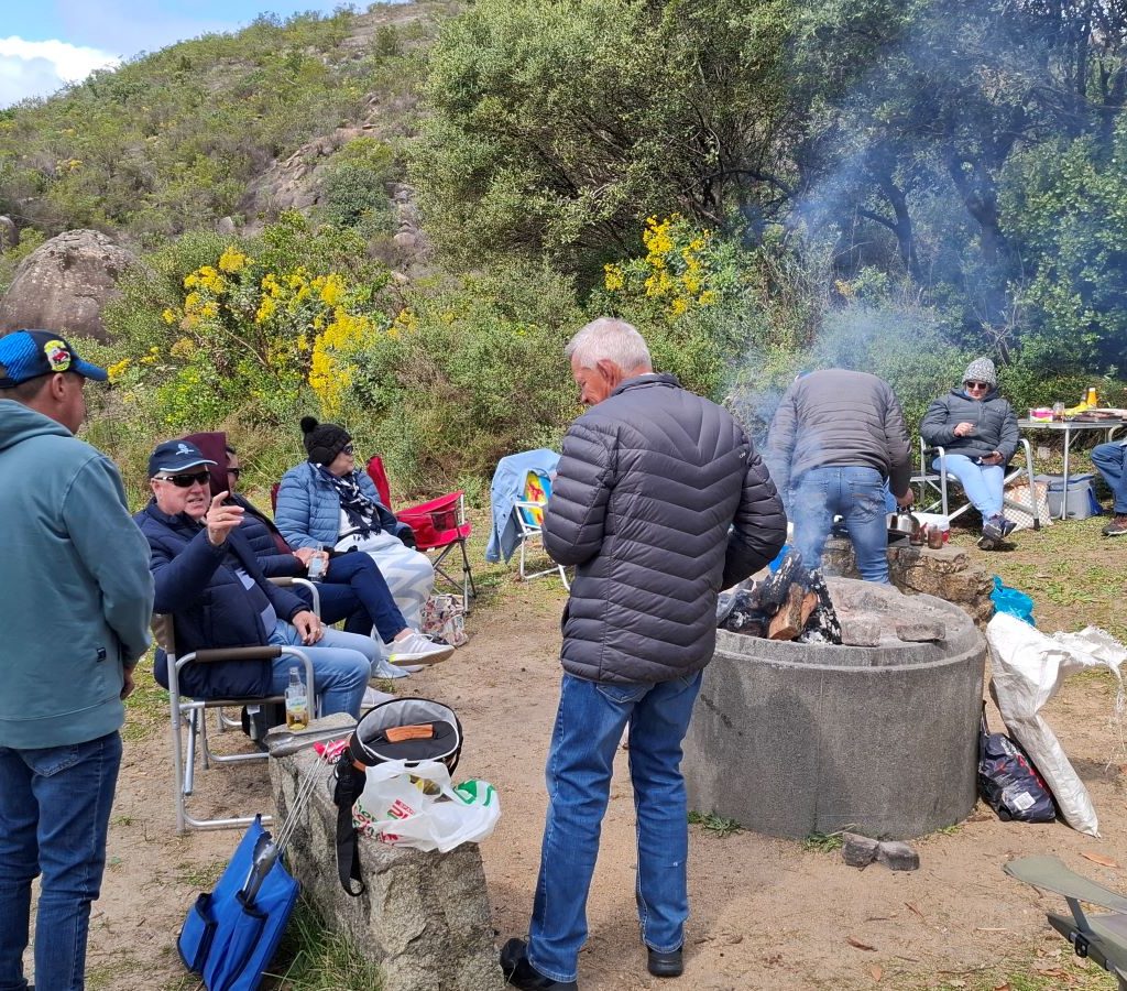 Wild Buggers Beach Buggy Club members gathered around the braai, chatting and relaxing after a day of driving.