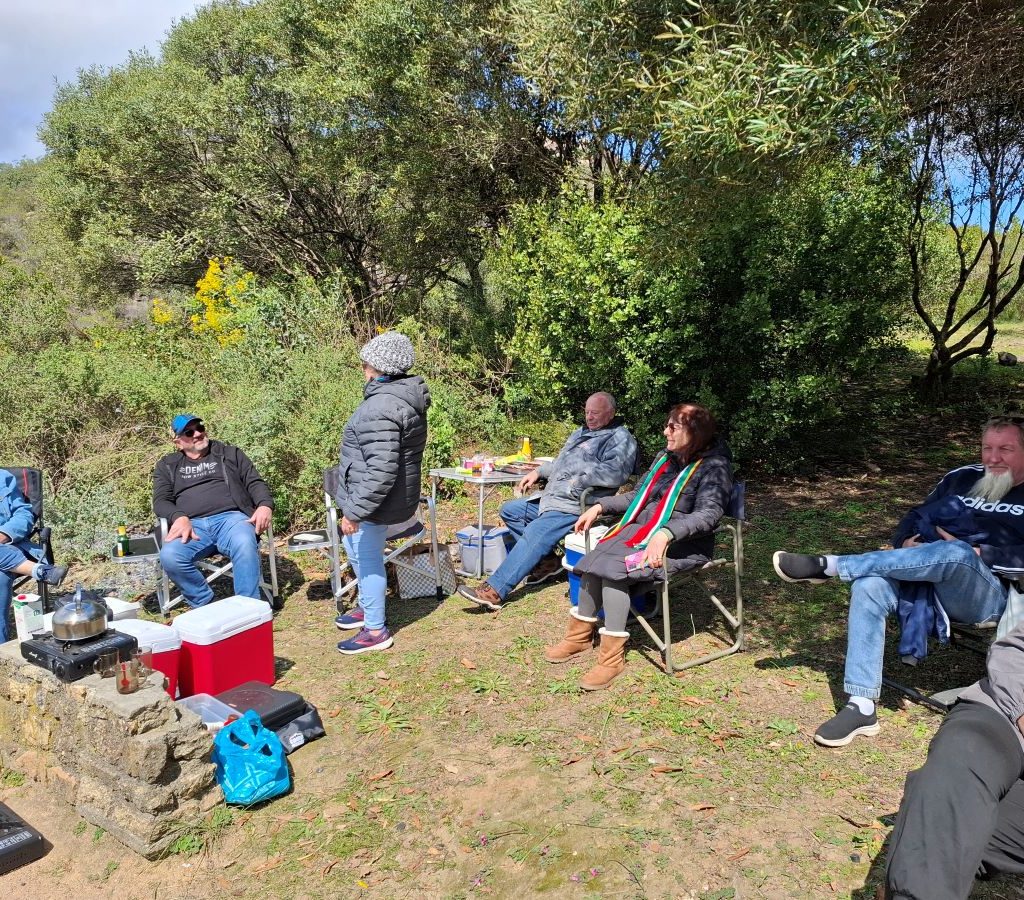 Wild Buggers Beach Buggy Club members sitting and relaxing while chatting during a club event.