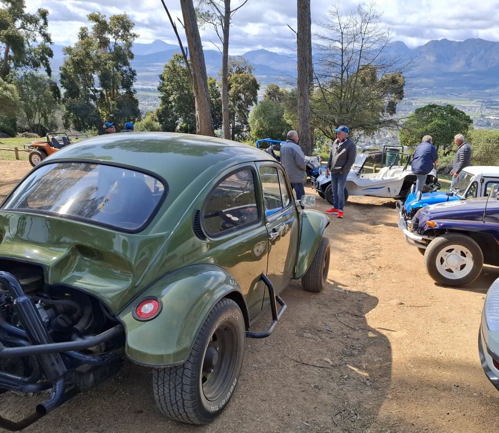 Mickey’s green Baja Bug with mountains in the background during the Wild Buggers Paarl Run.