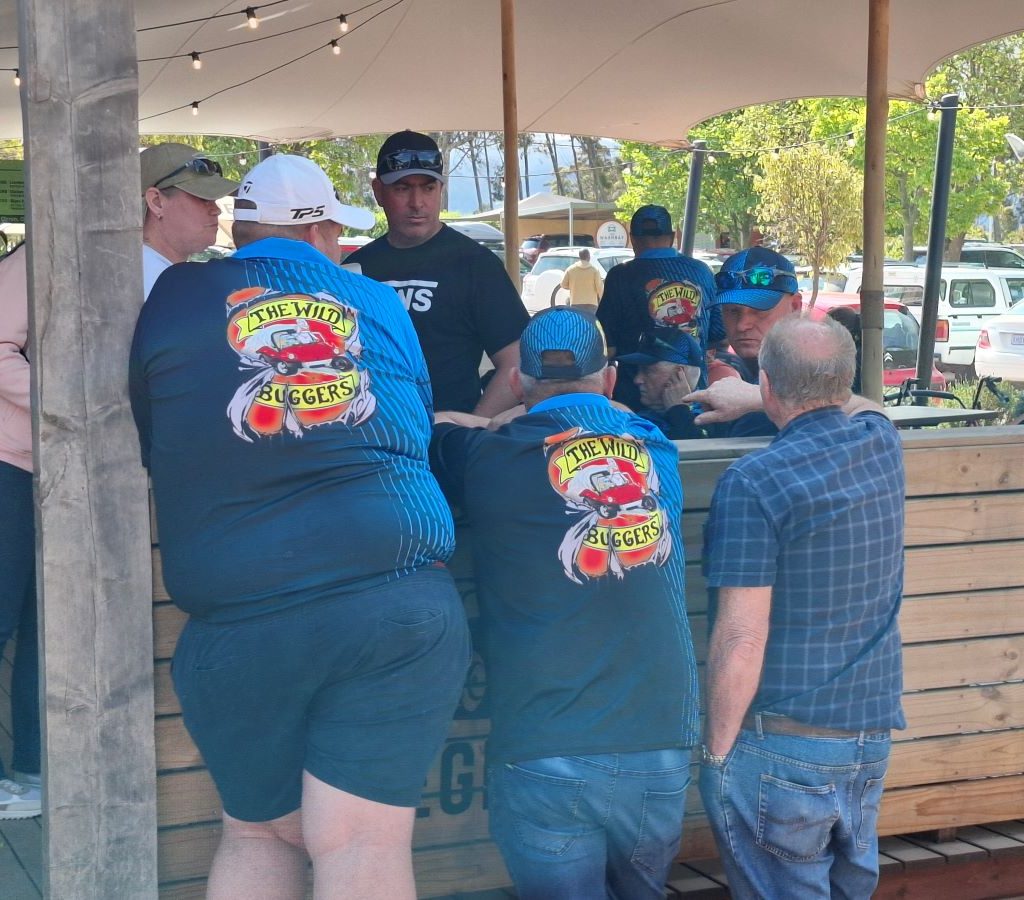 Three generations of Wild Buggers—a son, his father, and his grandfather—chatting during the Winelands Breakfast Run.