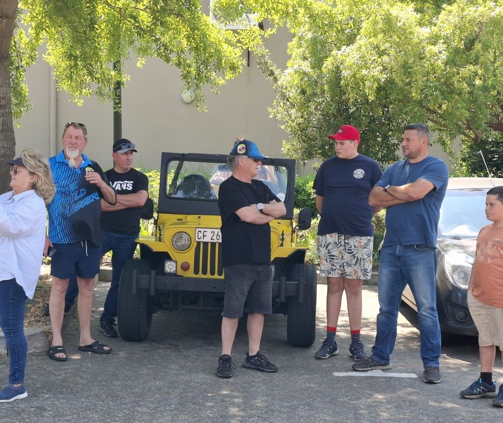 Wild Buggers members chatting with Cobus's VW air-cooled Veep in the background during the Winelands Breakfast Run.
