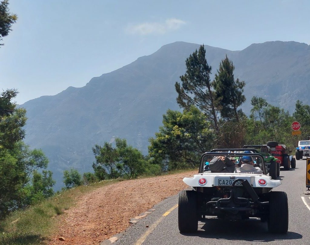 Beach buggies driving through a mountain pass during the Wild Buggers Winelands Breakfast Run.
