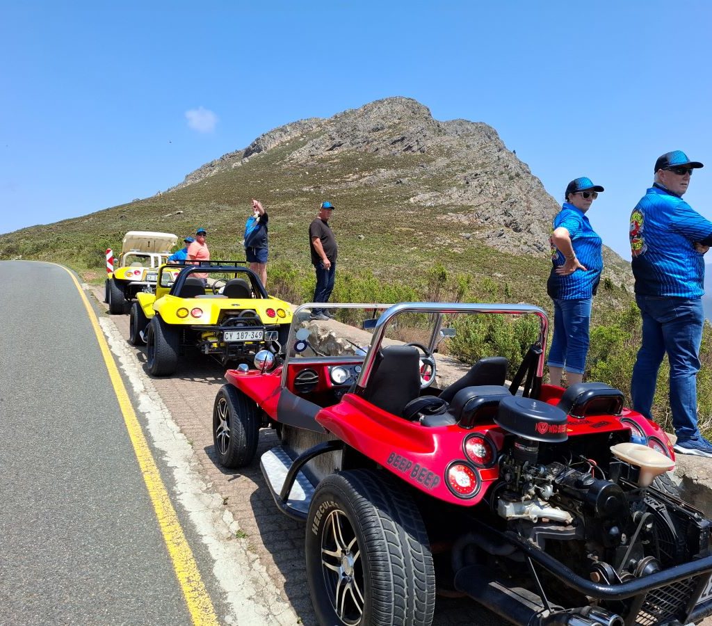 Wild Buggers members taking in the breathtaking mountain views during a scenic stop on the Winelands Breakfast Run