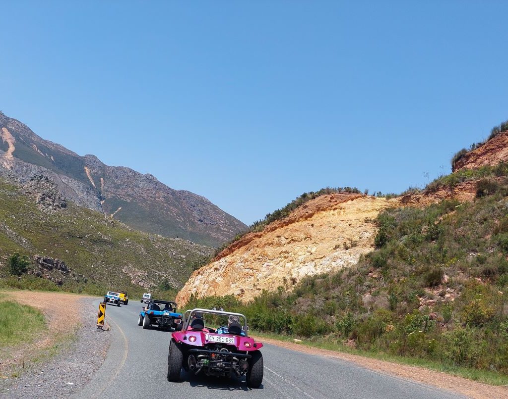 Beach buggies driving along scenic mountain roads during the Wild Buggers Winelands Breakfast Run.