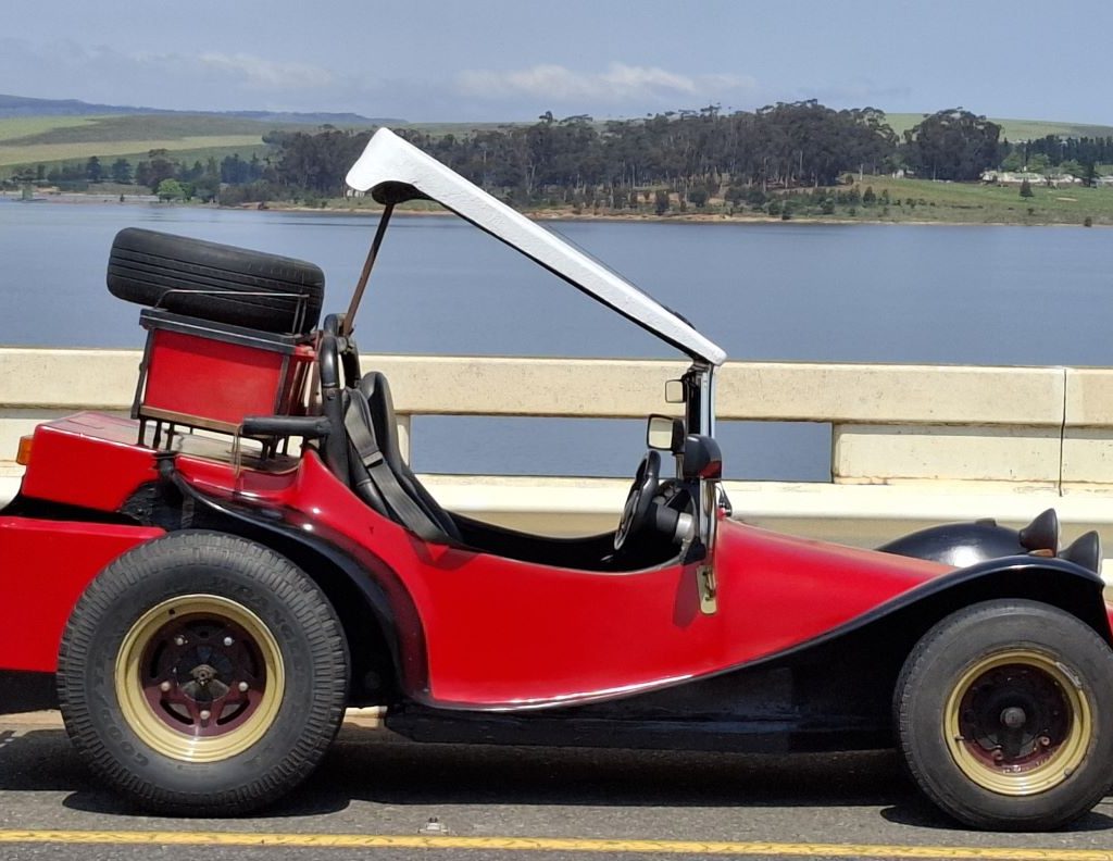 Hugo’s red T-Bug parked with the dam in the background during the Wild Buggers Winelands Breakfast Run.