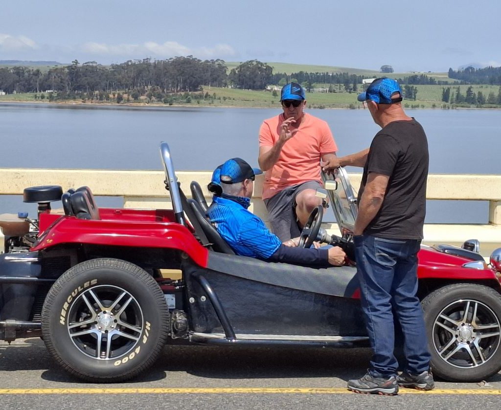 Theo and Elna sitting in their red Beamish bug while chatting with Brent and Antony during the Wild Buggers Winelands Breakfast Run.