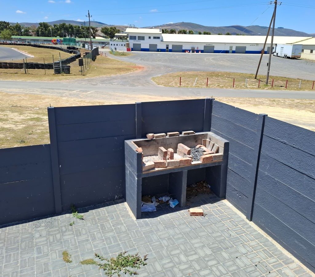Wild Buggers Beach Buggy Club members planning their charity event at Killarney International Raceway, inspecting the braai area for boerewors rolls.
