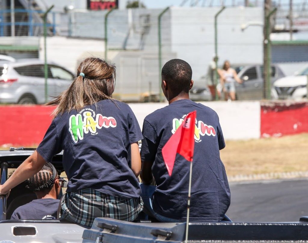 Rico Barlow driving his gray Kango beach buggy with a 1600 VW air-cooled Beetle motor, carrying children around the track at the Wild Buggers Beach Buggy Club's Killarney International Raceway charity run.