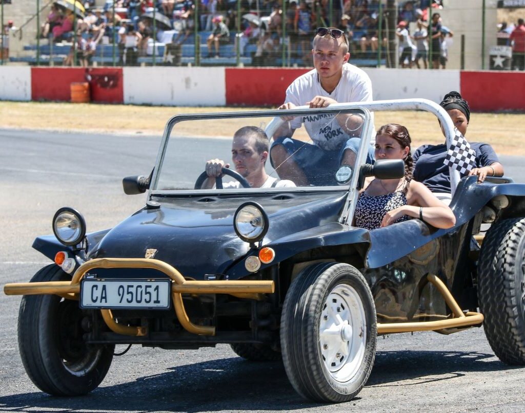 Ruan Ackerman driving his black Beamish beach buggy with a 1600 VW air-cooled Beetle motor, carrying children around the track at the Wild Buggers Beach Buggy Club's Killarney International Raceway charity run.