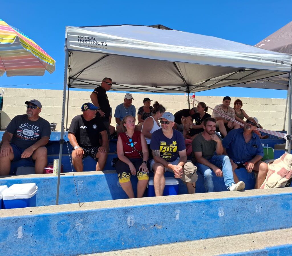 Excitement builds as Wild Buggers Beach Buggy Club members await children from four orphanages at Killarney International Raceway for their charity run, seated in pre-arranged grandstand seats.