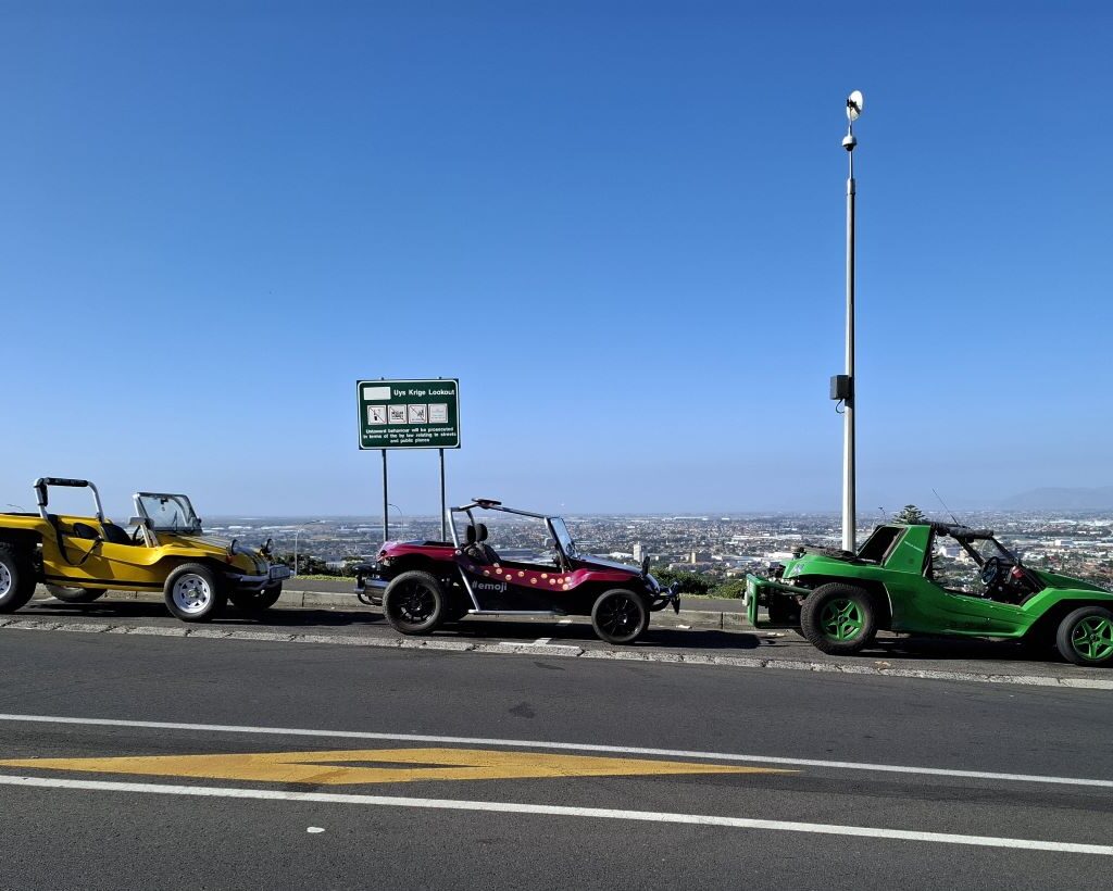 Three beach buggies, including Anton Kleyn's green "Shrek," Garry Fleming's pink "Emoji," and Wiehann's yellow Beamish, gather at the Wild Buggers Valentine's Run meeting point. All powered by VW air-cooled Beetle motors (except Shrek, who's a bit of a rebel).