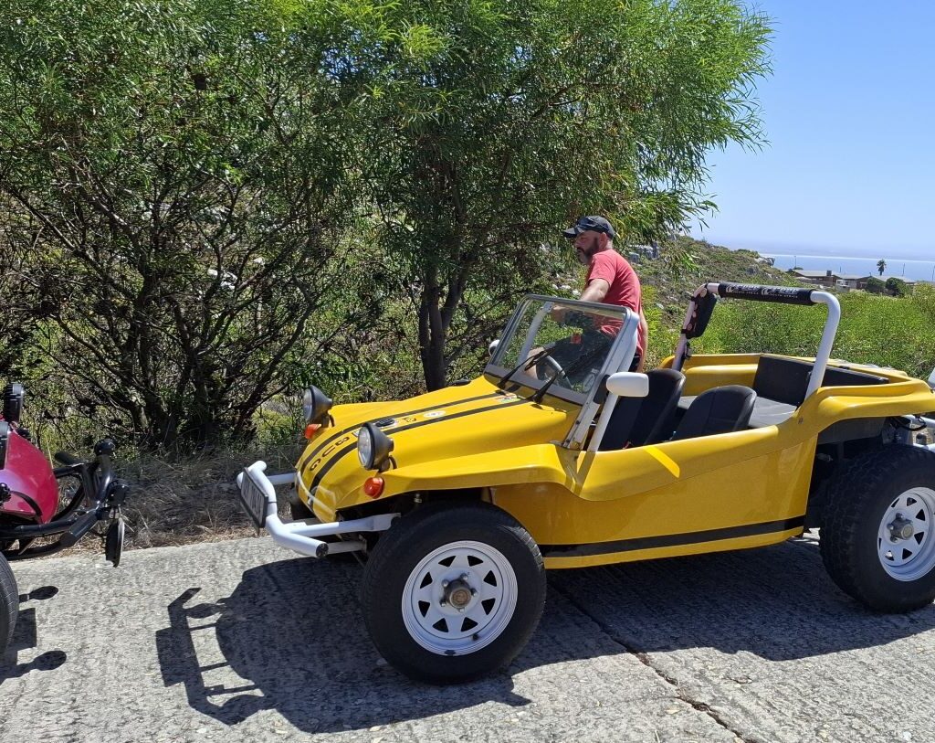 Wiehann Geldenhuys getting out of his yellow Beamish beach buggy, "Bug," at The Cannon in Simon's Town during the Wild Buggers Valentine's Day run.