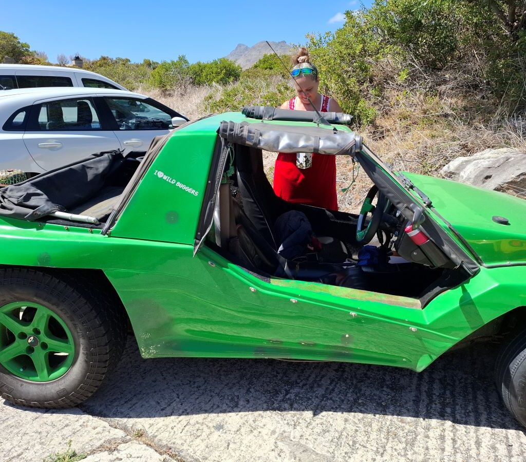 Mickey standing next to Anton Kleyn's green Kango beach buggy, "Shrek," at The Cannon in Simon's Town during the Wild Buggers Valentine's Day run.