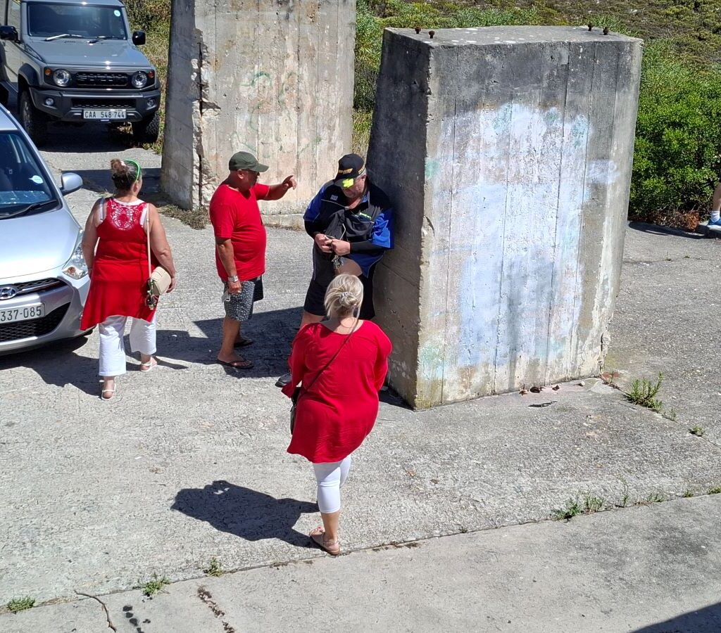 Wild Buggers Beach Buggy Club members exploring and chatting at a scenic location during their Valentine's Day run. Classic VWs parked nearby.