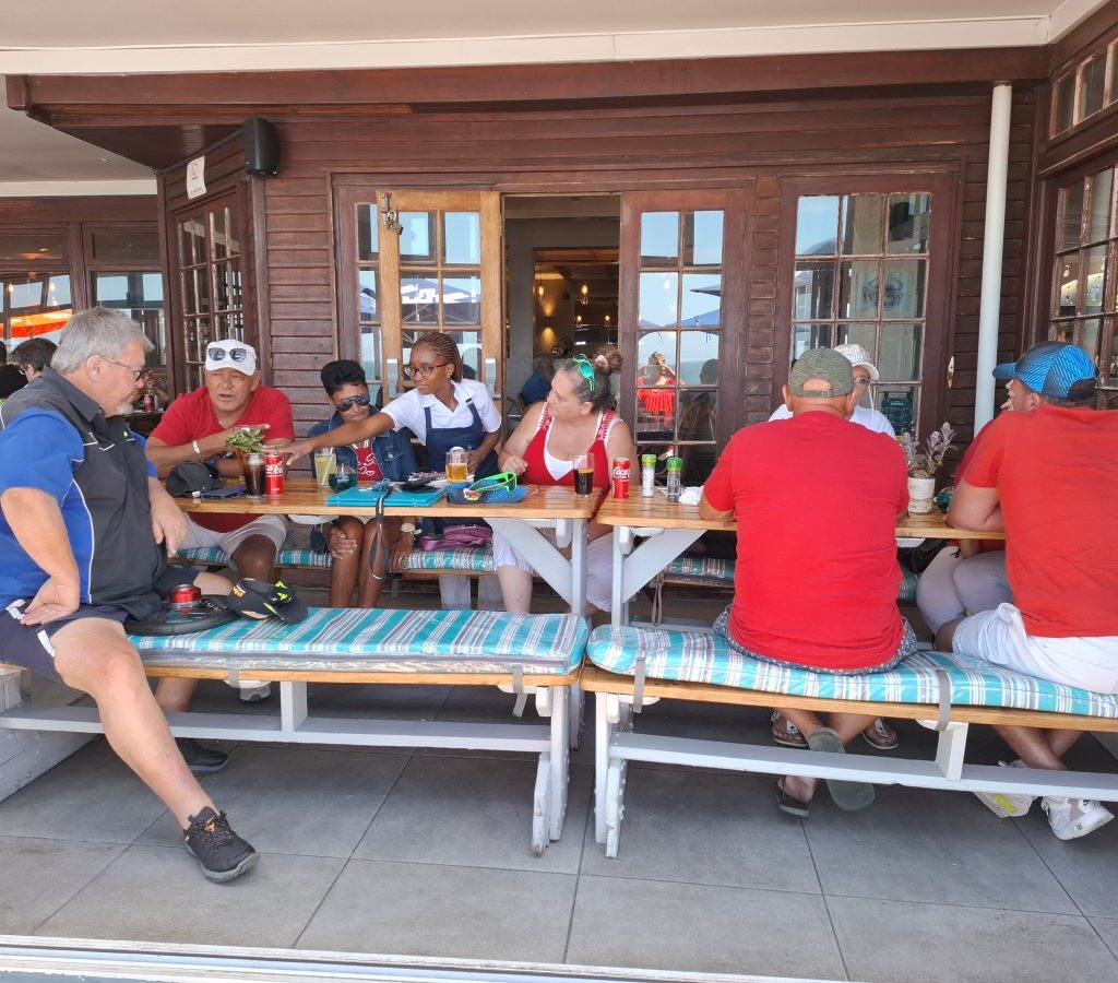 Wild Buggers Beach Buggy Club members having a casual chat at Dixie's Restaurant during their Valentine's Day run. Classic VWs likely parked nearby.
