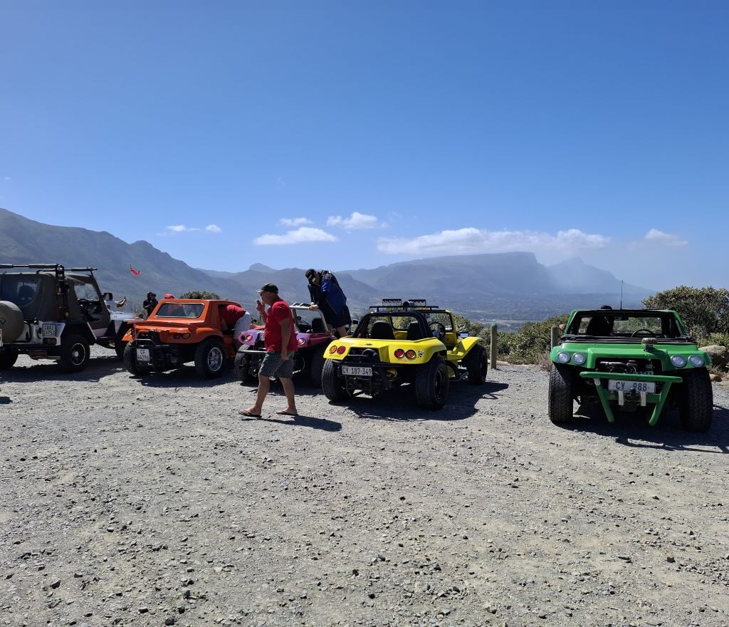 Anton Kleyn's "Shrek" Kango, Anthony and Michelle Jenkins' "Bumblebee" Salamander, Garry Fleming's "Emoji" Beamish, Brent Van Der Weijde's "Mango" Salamander, and Faizal and Ayesha Williams' Jeep parked at a scenic lookout point during the Wild Buggers Beach Buggy Club's Valentine's Day run.