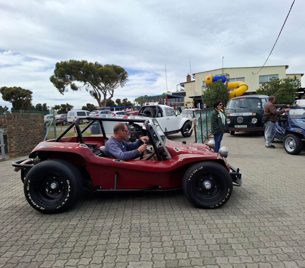 A photo of Wild Buggers beach buggies lined up at the Killarney International Raceway track, ready to take the Reach for a Dream children for another ride.