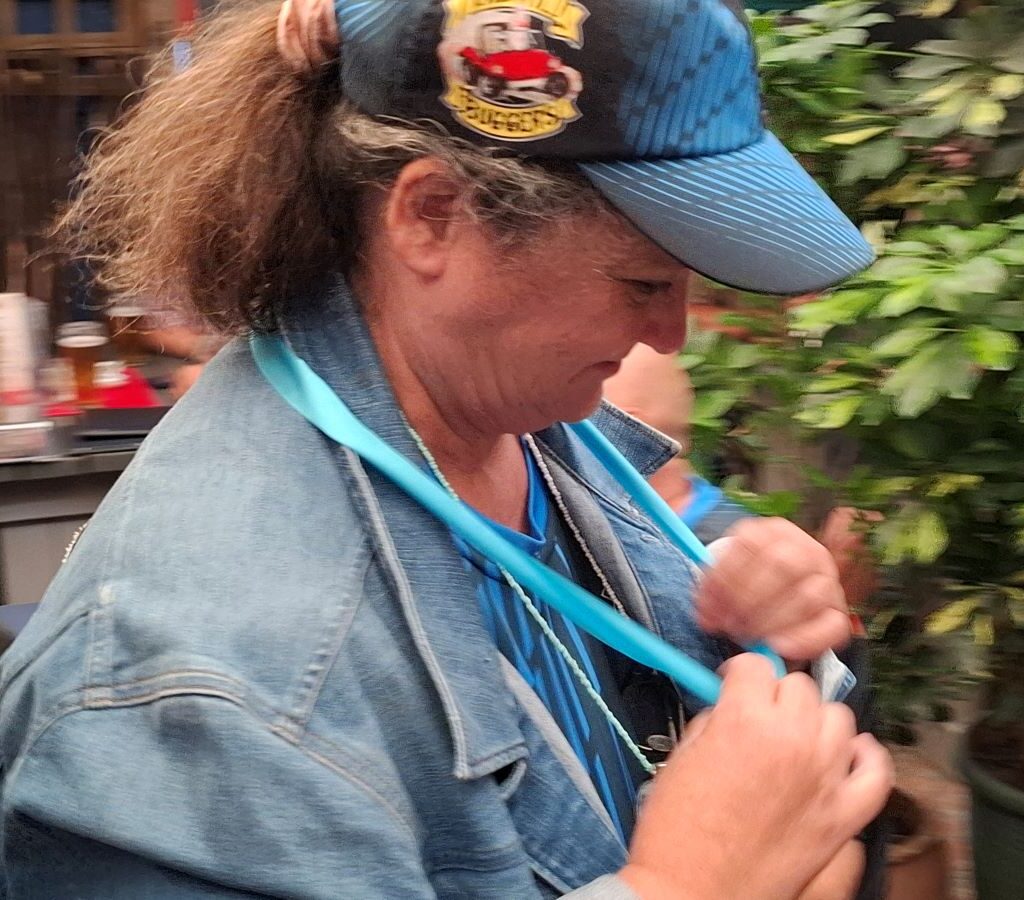 Mickey proudly receiving her Cape Buggy Tour 2025 medal, celebrating a successful finish with her Baja Bug.