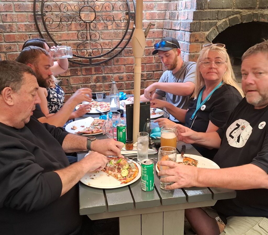 Ralph, the organizer of the Cape Buggy Tour 2025, chatting with fellow participants after handing out medals, with the event still going strong.