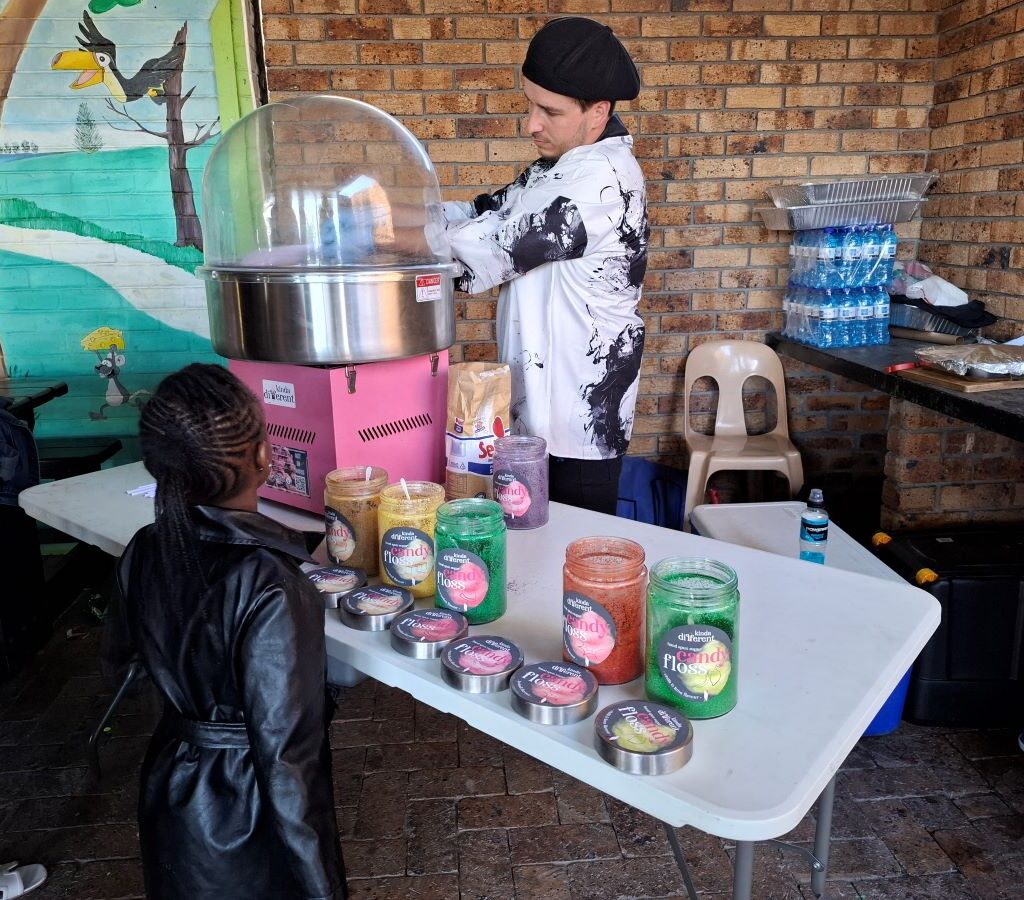A photo of Justin Du Plessis making candy floss for the Reach for a Dream children at the Wild Buggers Beach Buggy Club's charity run.