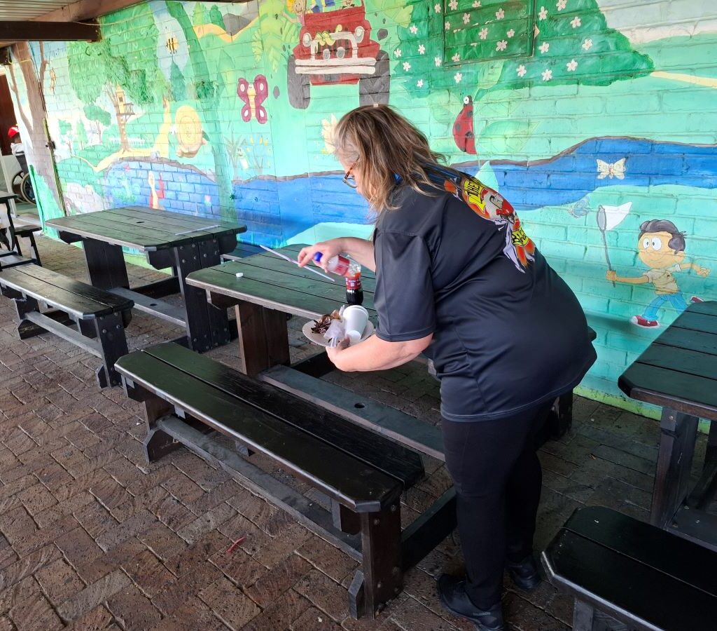 A photo of Lizette Neveling helping with the cleanup efforts at the Wild Buggers Reach for a Dream charity run.