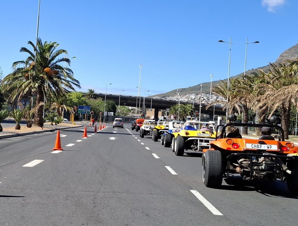 A convoy of classic beach buggies cruising through the Cape during the Cape Buggy Tour 2025.