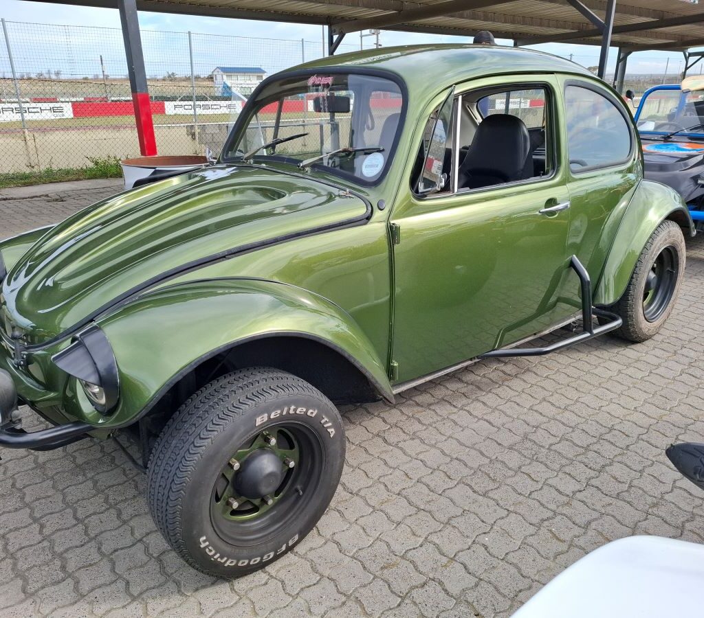 Mickey Van Blerk's dark green Baja Bug, nicknamed "The Dark Side," at the Wild Buggers Reach for a Dream charity run, showcasing its rugged, off-road style.